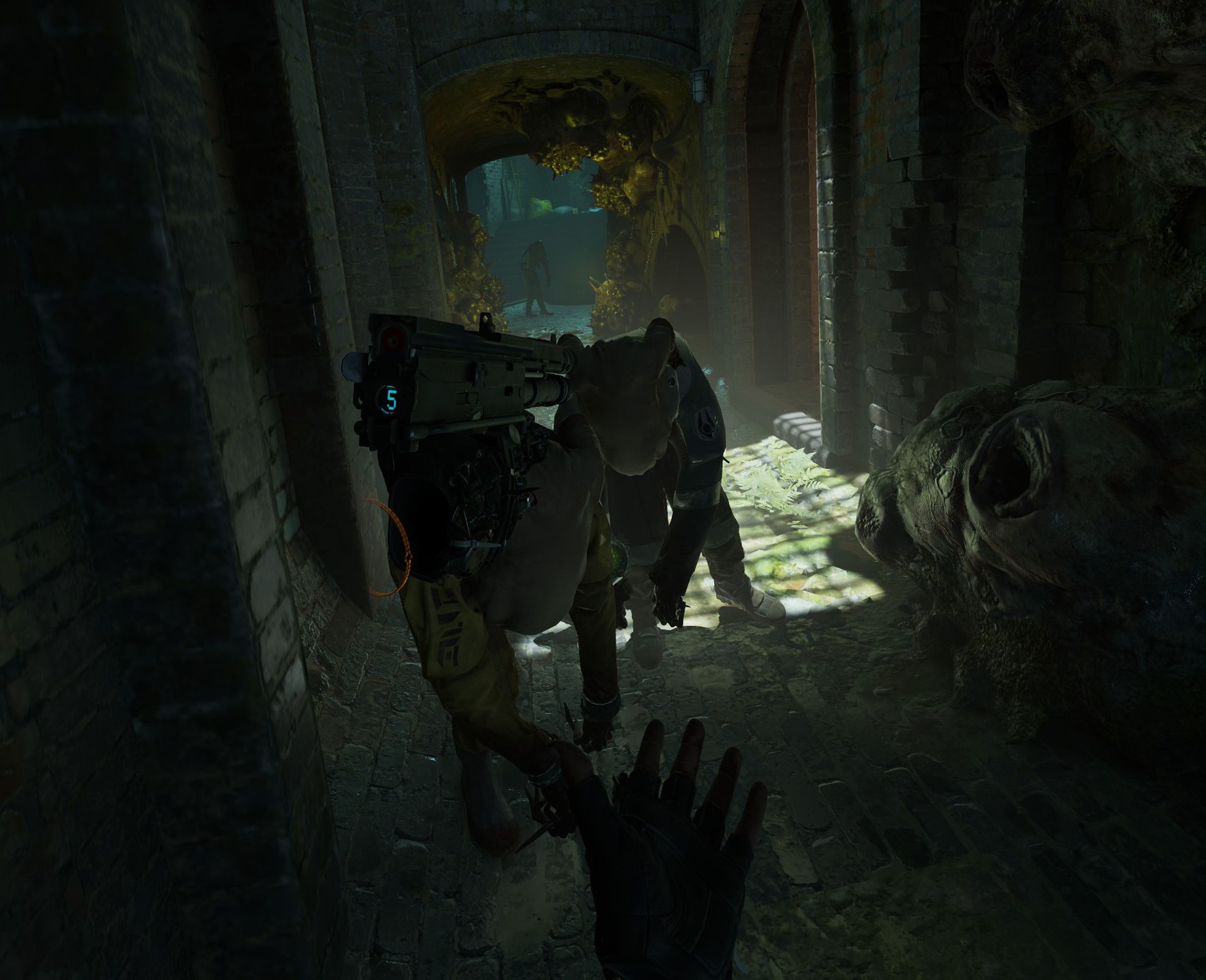 One disembodied hand floats in air holding a shortened high-tech shotgun.
